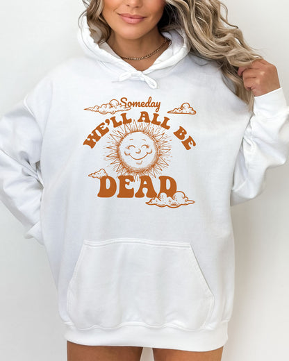 Woman wearing a white hoodie featuring a funny retro-style laughing sun graphic and the quote 'Someday We'll All Be Dead'.
