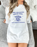 Woman wearing a white hoodie with a funny retro cowboy raccoon graphic and the phrase 'Sorry For Having Great Tits And Correct Opinions'.
