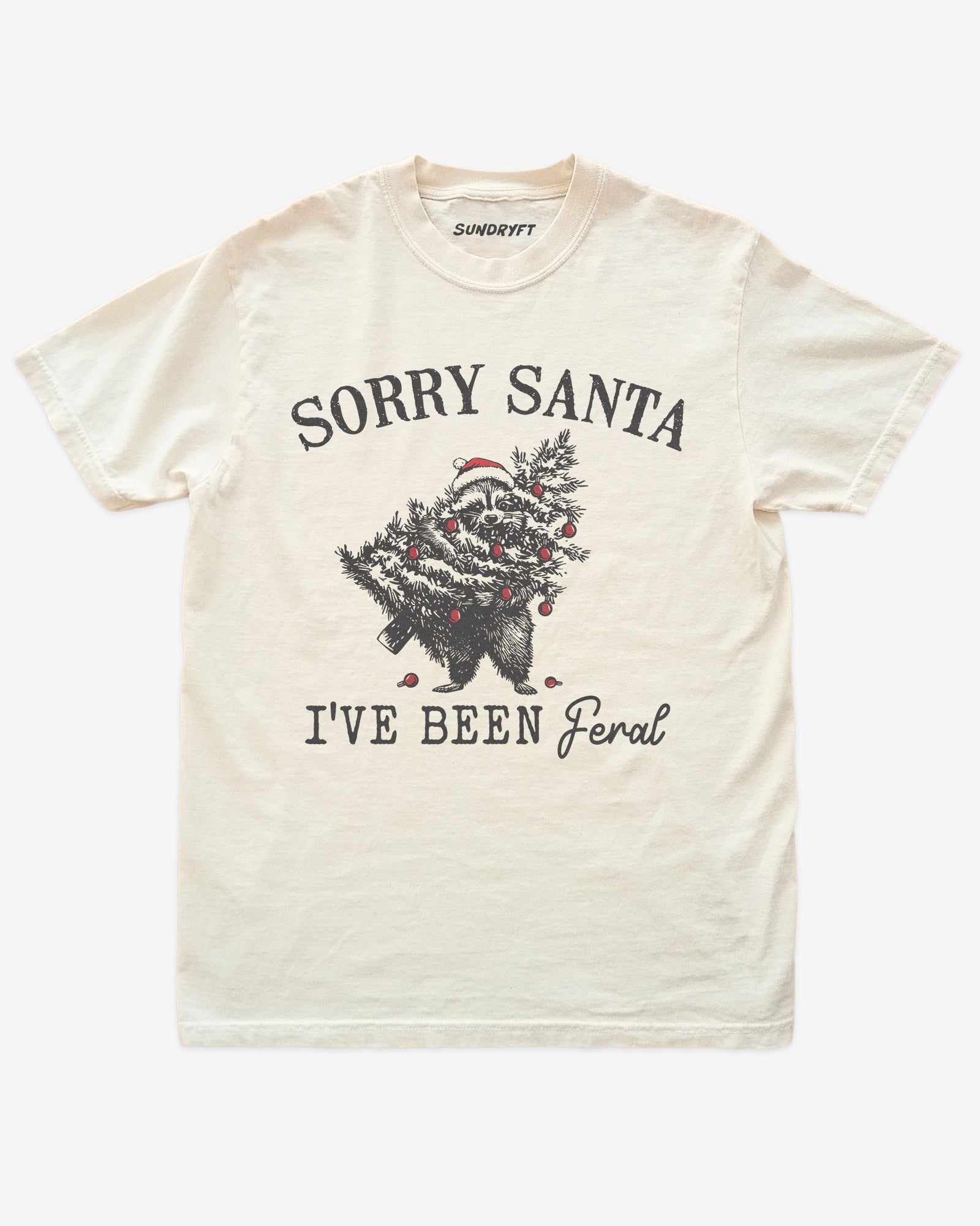 Sorry Santa I've Been Feral shirt in ivory with raccoon eating Christmas tree graphic