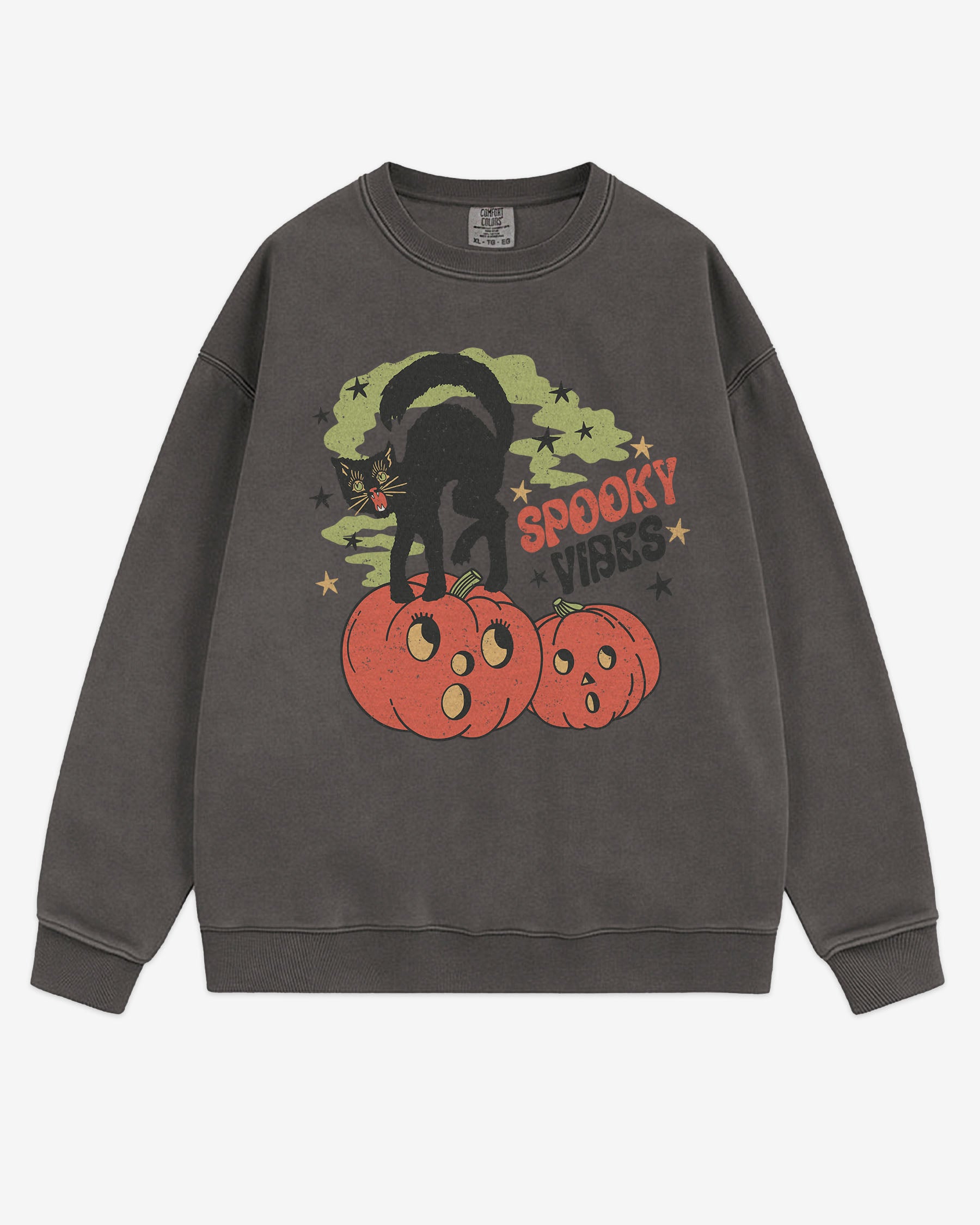Flat lay pepper Halloween sweatshirt reading ‘Spooky Vibes’ with retro graphic of black cat standing on pumpkins.