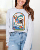 Model wearing ash color long sleeve tee with 'Stay Positive Shark' graphic design