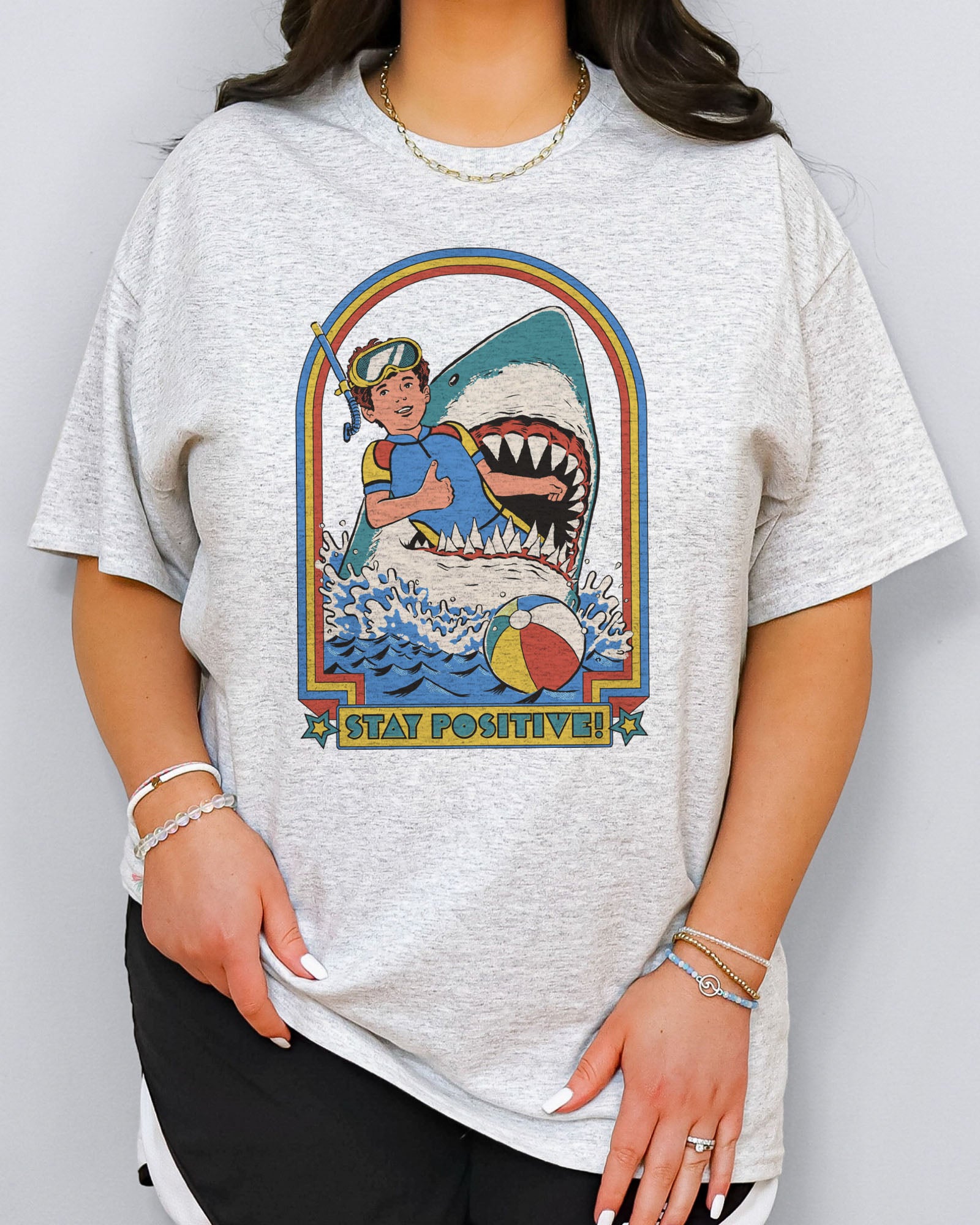 Model wearing ash color shirt with 'Stay Positive' diver in sharks mouth graphic design