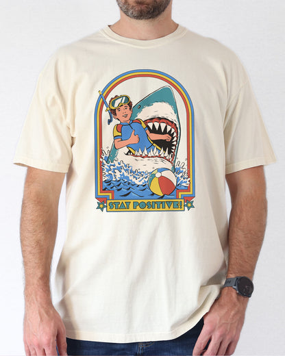 Model wearing natural color shirt with 'Stay Positive' diver in sharks mouth graphic design
