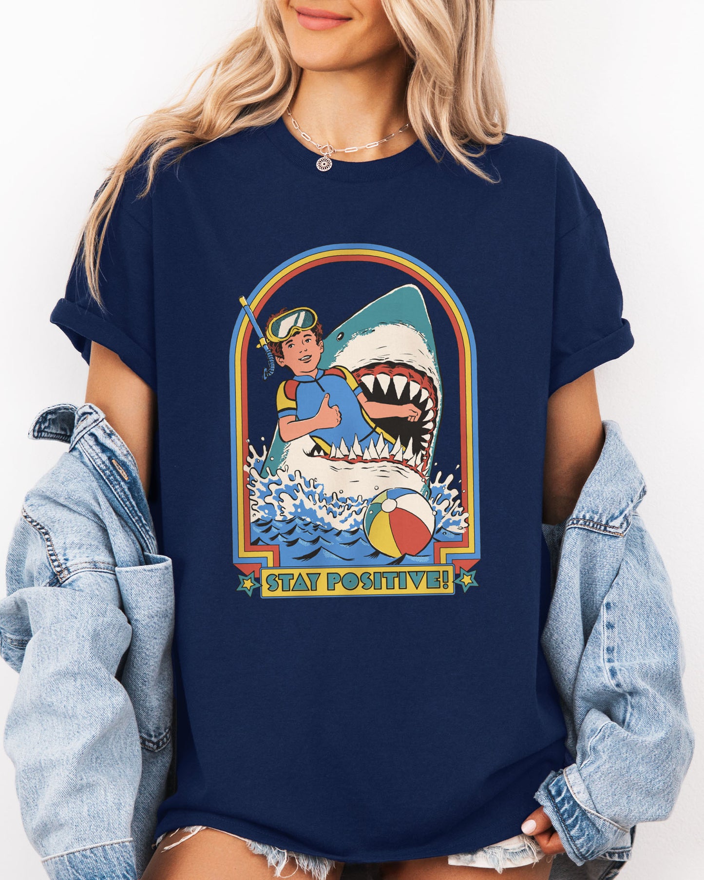 Model wearing navy color shirt with 'Stay Positive' diver in sharks mouth graphic design