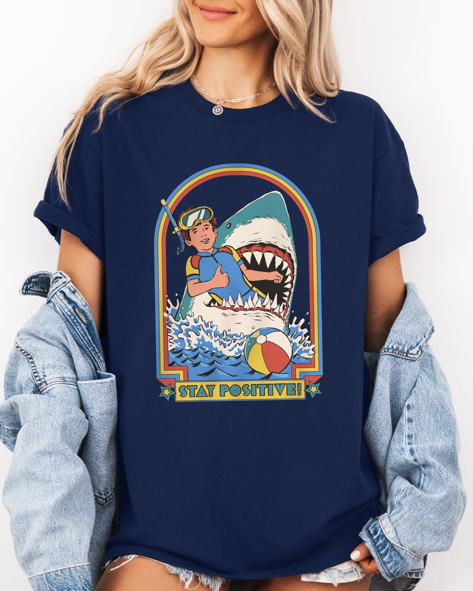 Model wearing navy color shirt with 'Stay Positive' diver in sharks mouth graphic design