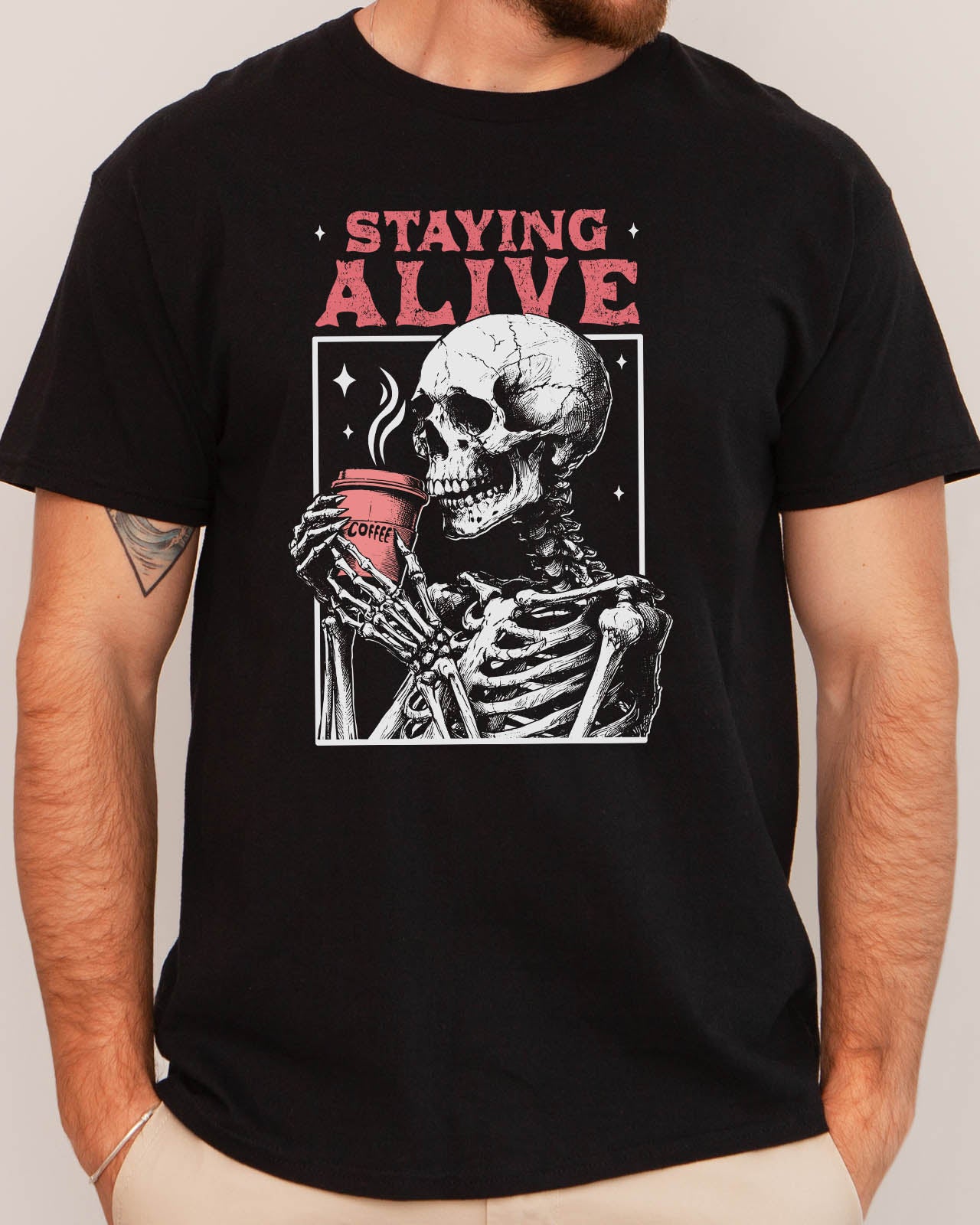 Man wearing Staying Alive shirt in black color with a funny retro skeleton coffee graphic