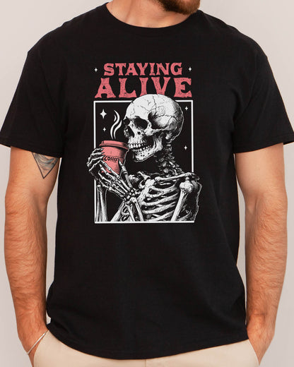 Man wearing Staying Alive shirt in black color with a funny retro skeleton coffee graphic