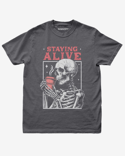 Staying Alive shirt in pepper with skeleton drinking coffee graphic