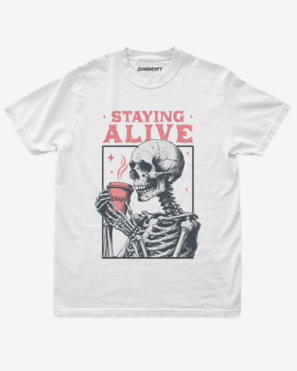 Staying Alive shirt in white with skeleton drinking coffee graphic