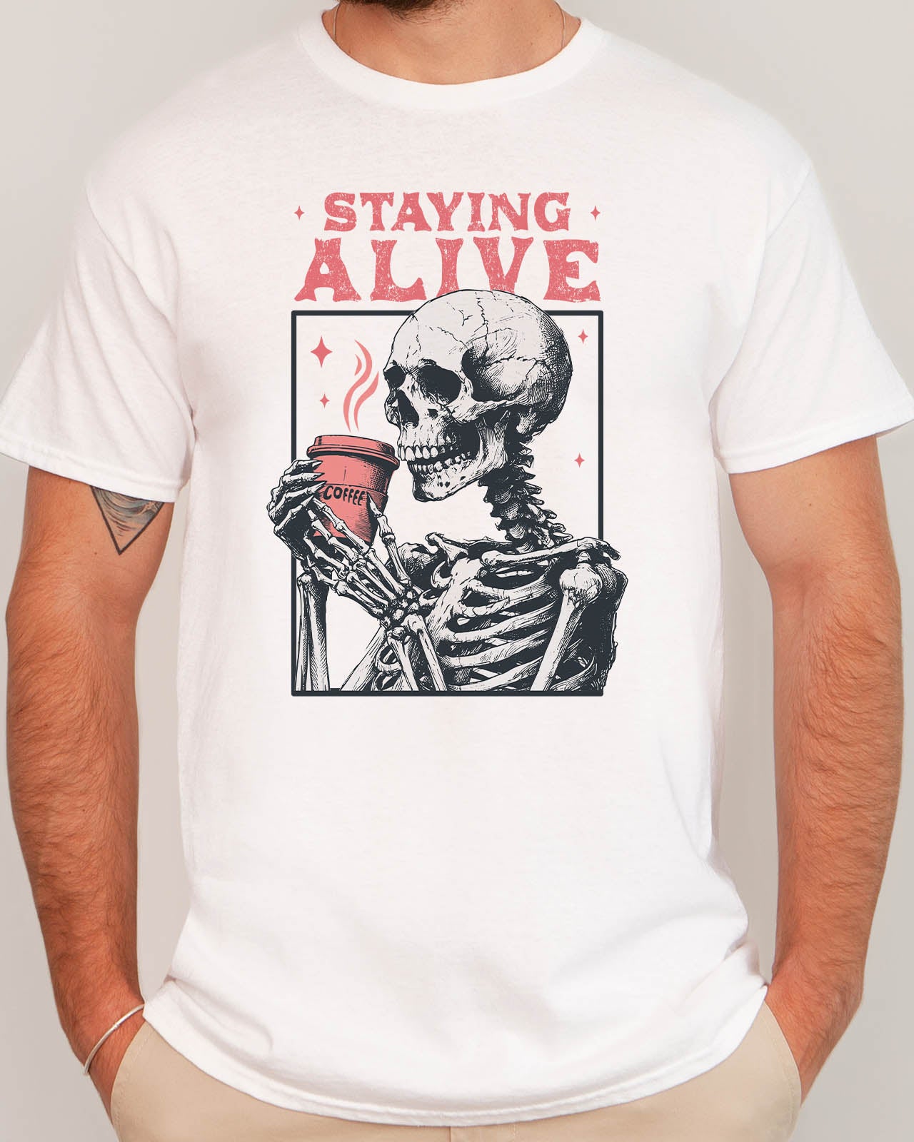 Man wearing Staying Alive shirt in white color with a funny retro skeleton coffee graphic