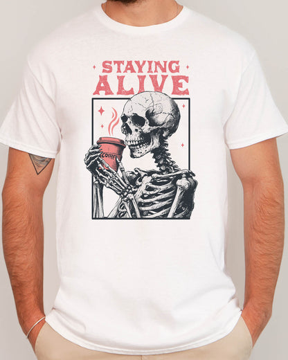 Man wearing Staying Alive shirt in white color with a funny retro skeleton coffee graphic