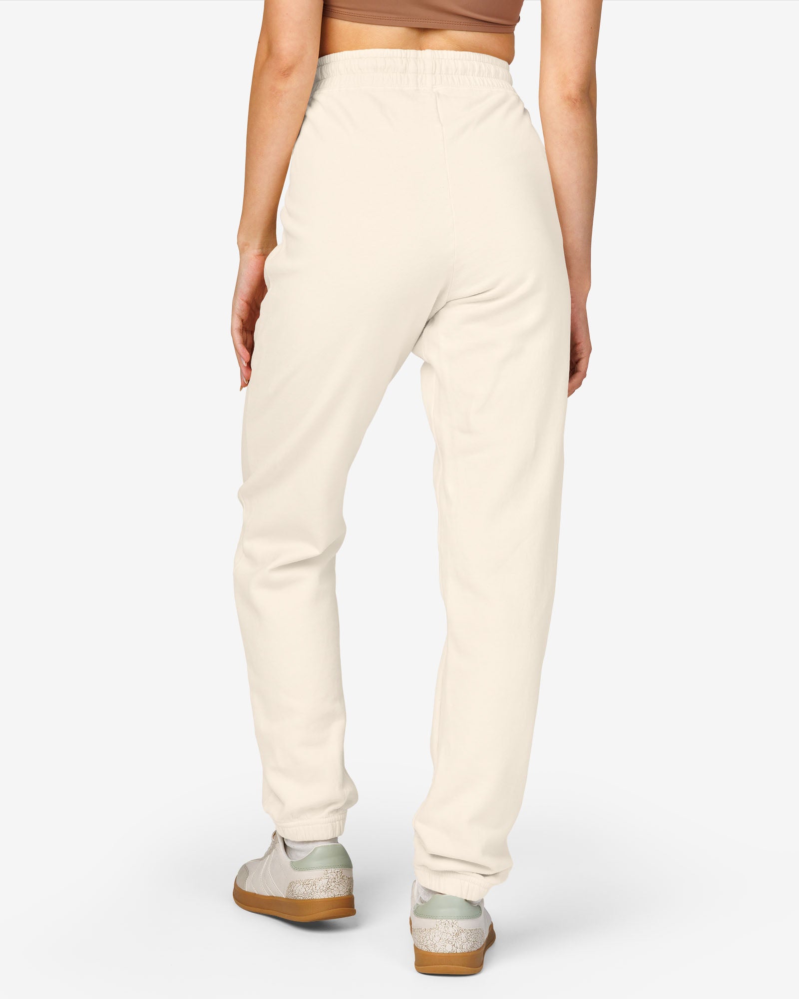 Woman wearing ivory color Sundryft unisex fleece sweatpants.