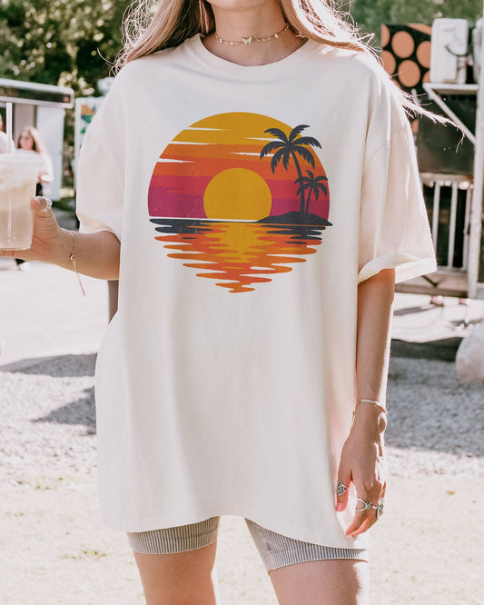 Model wearing ivory color shirt with retro sunset graphic design