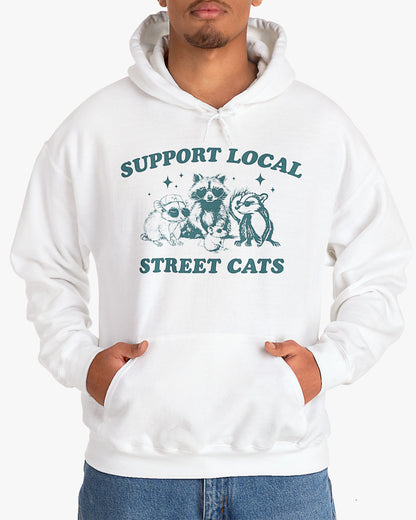Man wearing white 'Support Local Street Cats' hoodie with funny retro raccoon and opossum graphic