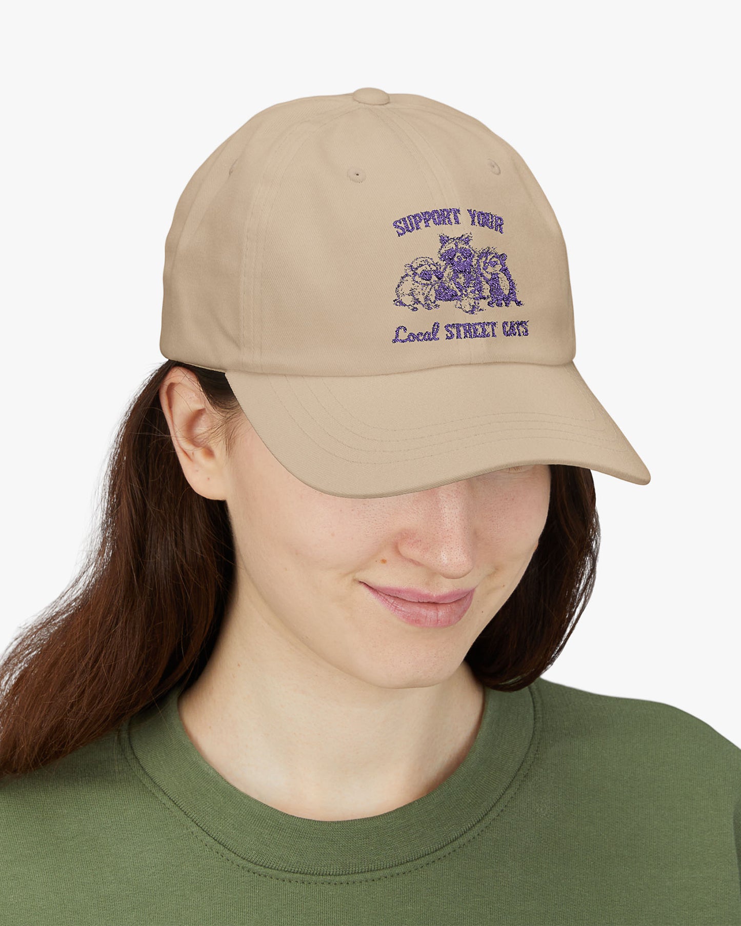 Woman wearing beige dad cap with the quote 'Support Your Local Street Cats' and a funny retro raccoon and opossum graphic.
