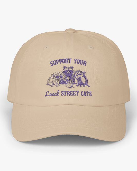 Beige dad cap with the quote 'Support Your Local Street Cats' and a funny retro raccoon and opossum graphic.