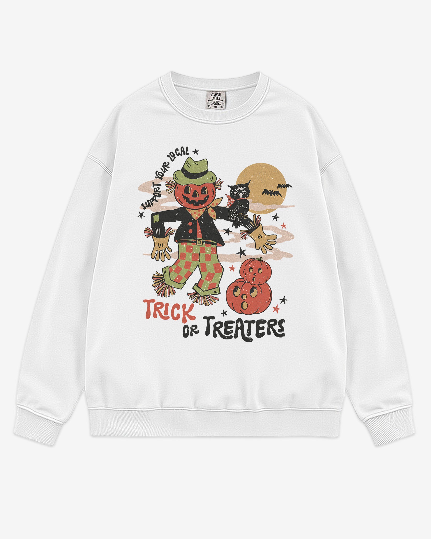Flat lay white Halloween sweatshirt reading ‘Support Your Local Trick Or Treaters’ with retro graphic of scarecrow, owl, and pumpkins.