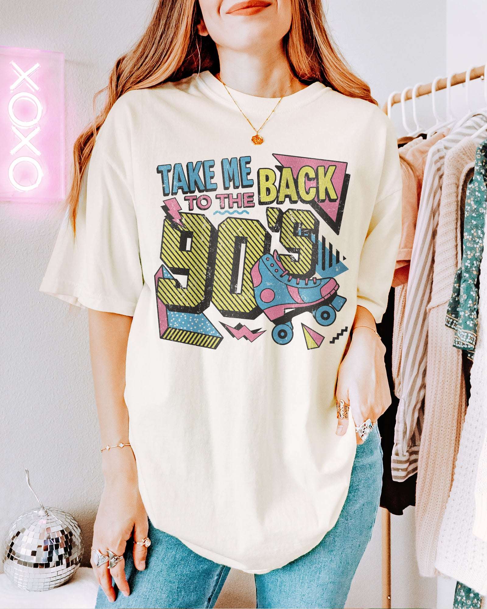 Woman wearing an ivory "Take Me Back To The 90's" retro graphic shirt.