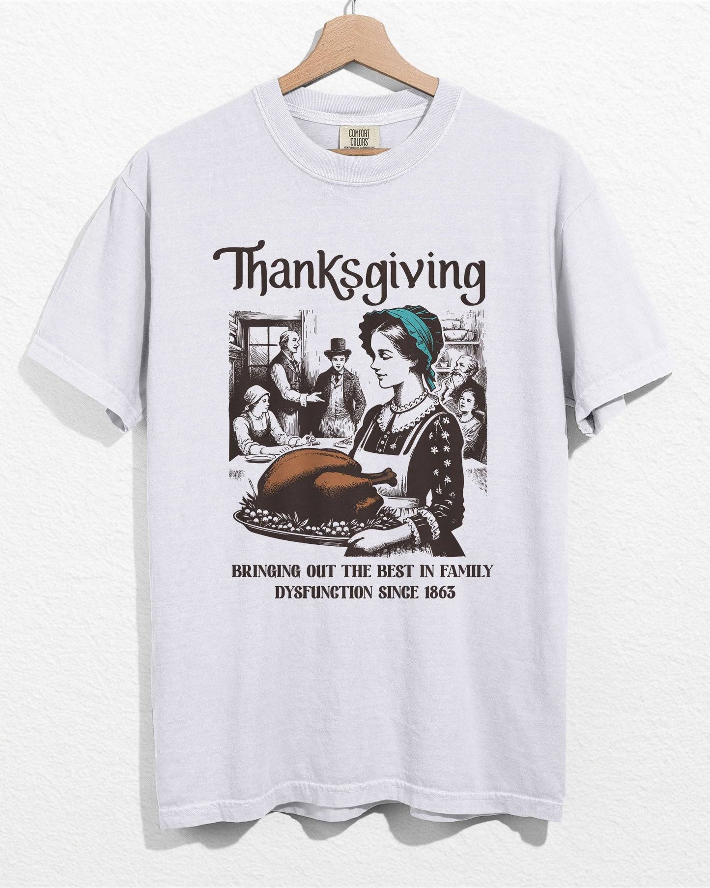 White color hanger shirt with 'Thanksgiving - Bringing Out The Best In Family Dysfunction Since 1863' graphic design