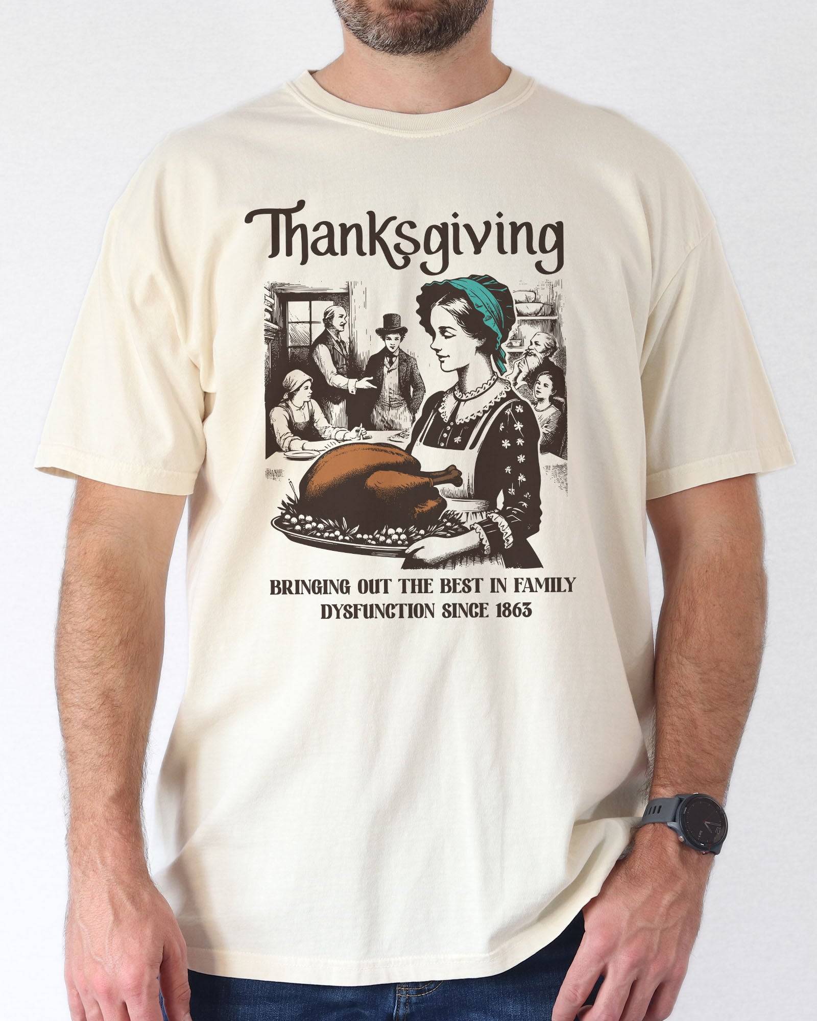 Model wearing ivory color shirt with 'Thanksgiving - Bringing Out The Best In Family Dysfunction Since 1863' graphic design