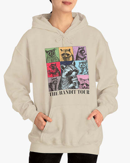 Woman wearing sand beige 'The Bandit Tour' hoodie with funny retro raccoon collage 