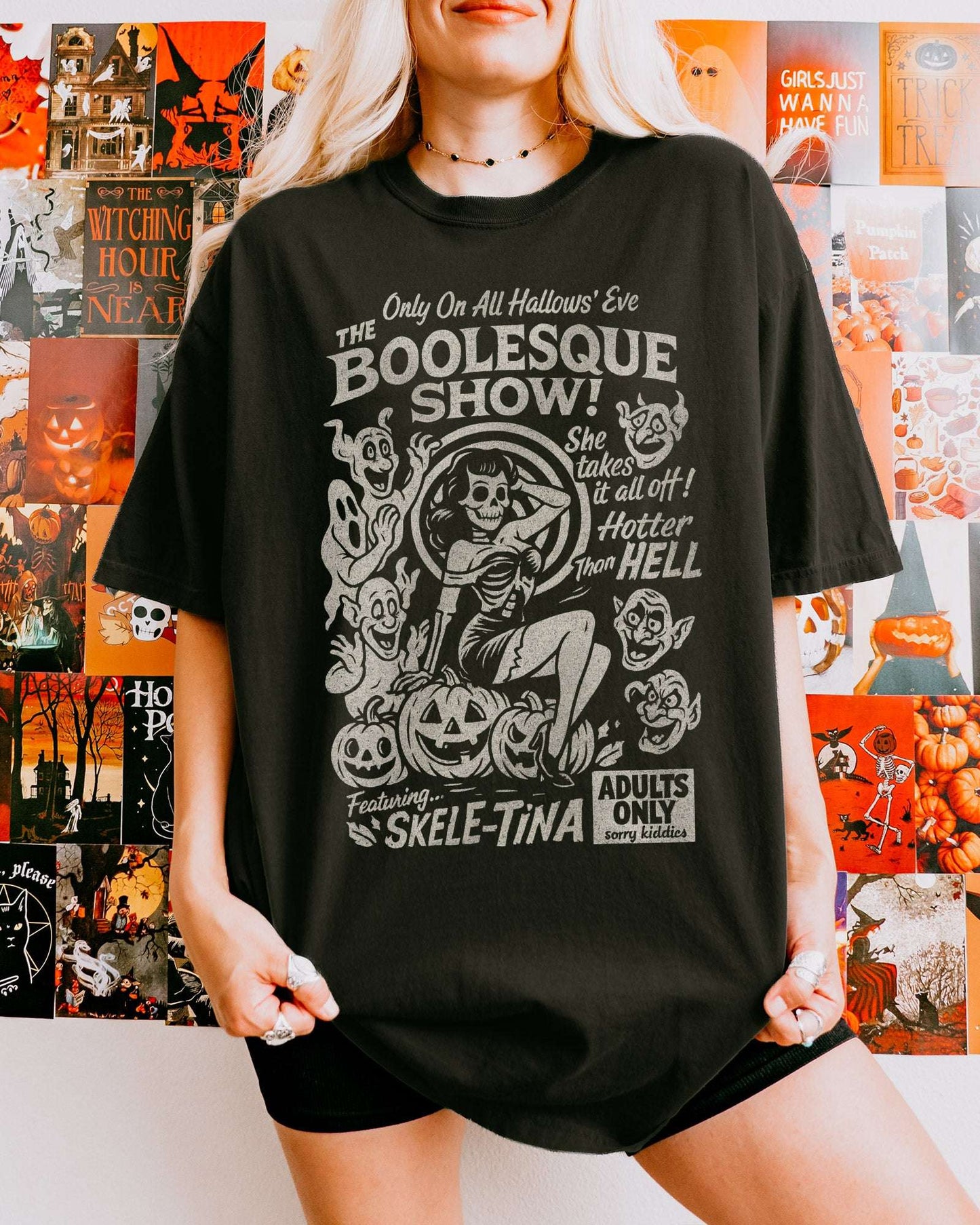 Woman wearing black "The Boolesque Show" Shirt with retro Halloween graphic of burlesque skeleton 