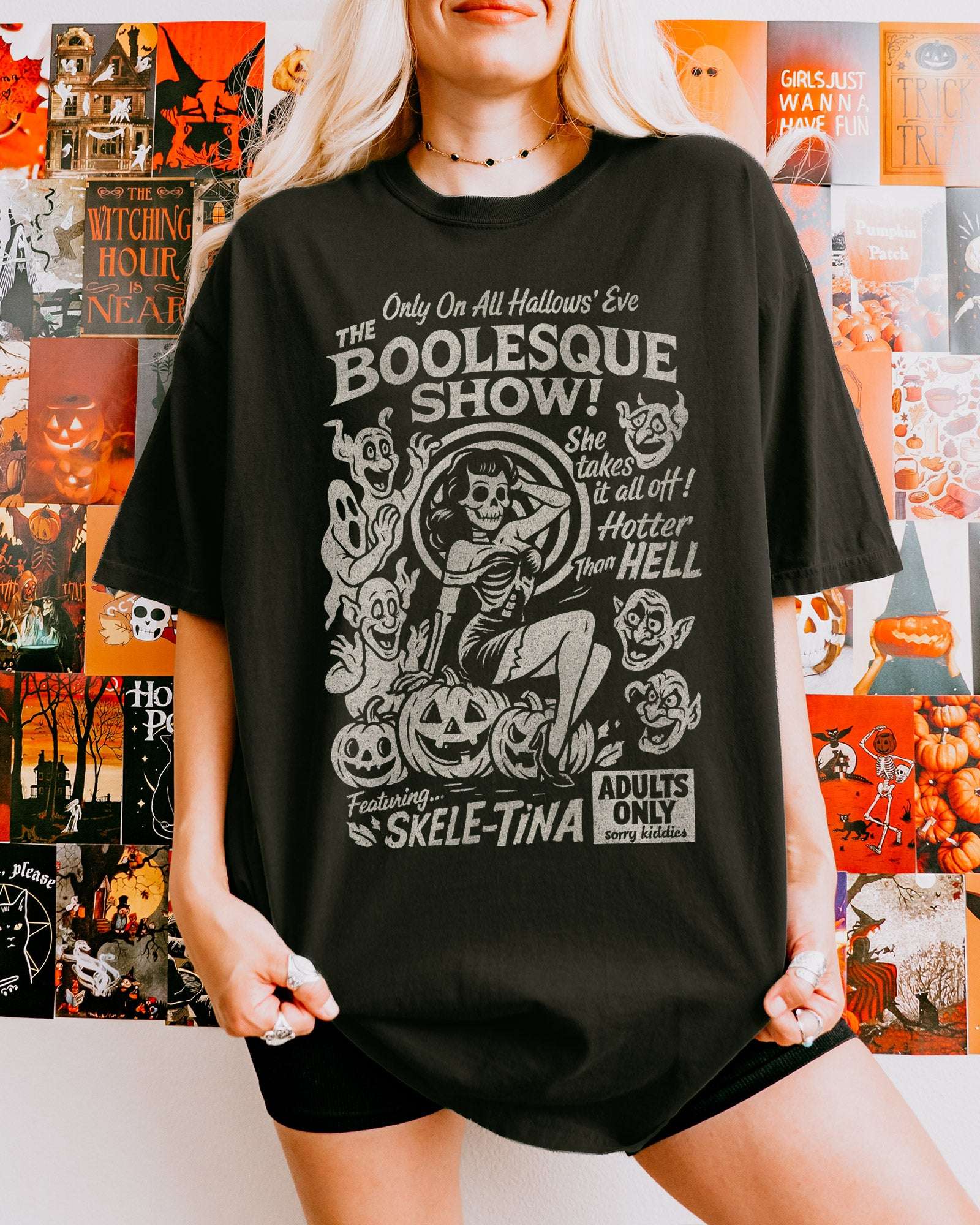 Woman wearing black "The Boolesque Show" Shirt with retro Halloween graphic of burlesque skeleton 