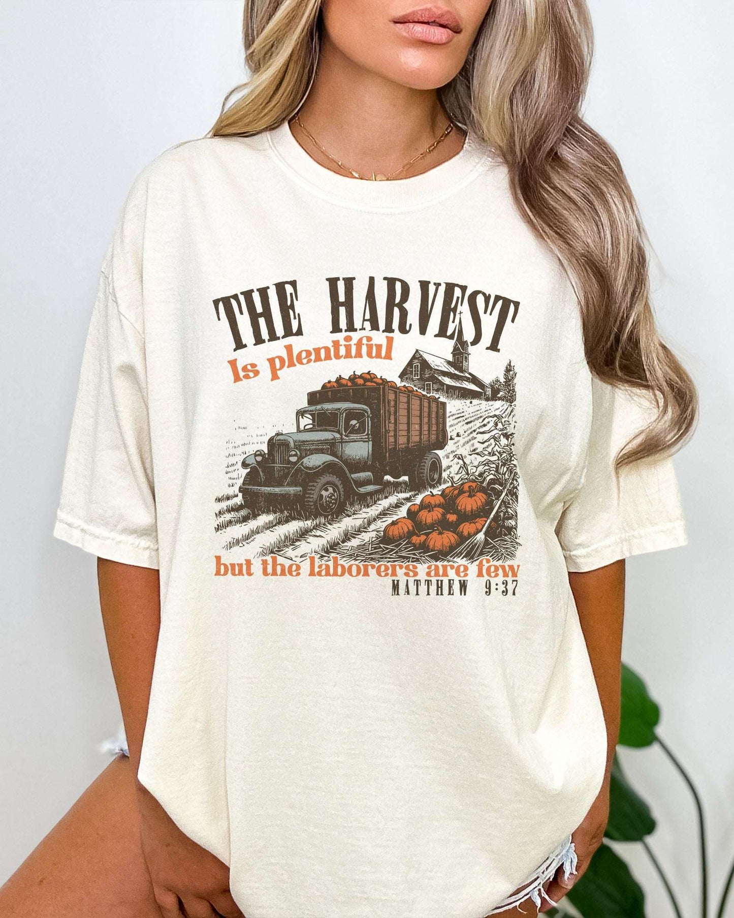 Model wearing ivory color shirt with 'The Harvest Is Plentiful, But The Laborers Are Few - Matthew 9:37' Thanksgiving graphic design
