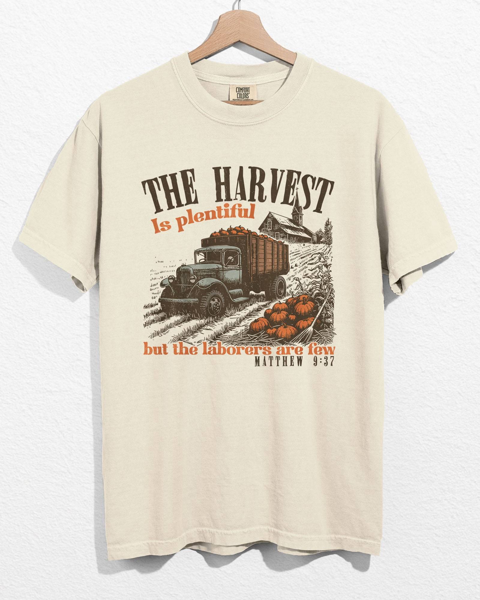 Ivory color hanging shirt with 'The Harvest Is Plentiful, But The Laborers Are Few - Matthew 9:37' Thanksgiving graphic design