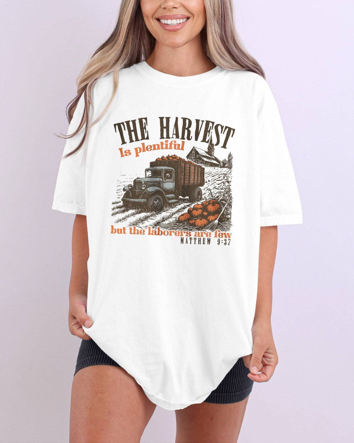 Model wearing ivory color shirt with 'The Harvest Is Plentiful, But The Laborers Are Few - Matthew 9:37' Thanksgiving graphic design