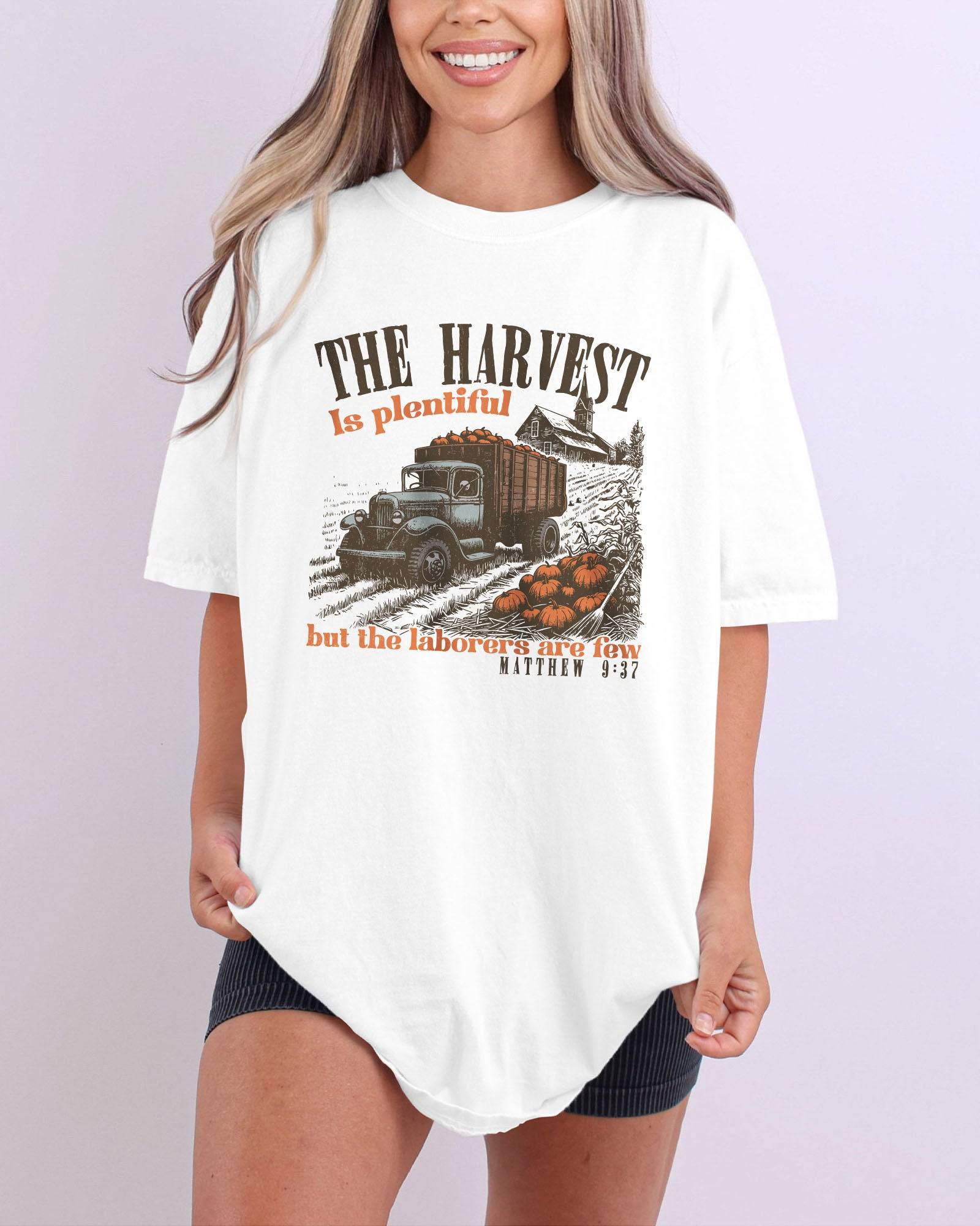 Model wearing ivory color shirt with 'The Harvest Is Plentiful, But The Laborers Are Few - Matthew 9:37' Thanksgiving graphic design