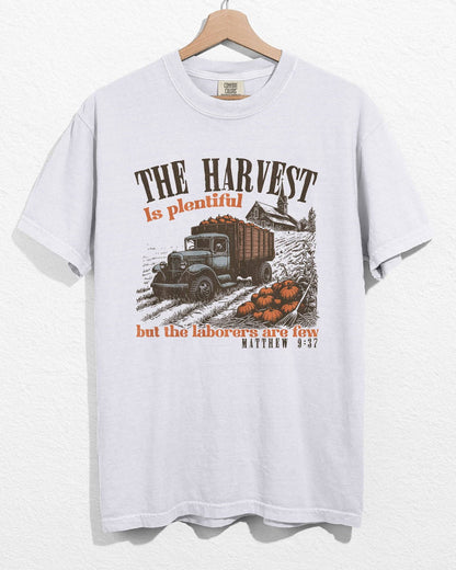 White color hanging shirt with 'The Harvest Is Plentiful, But The Laborers Are Few - Matthew 9:37' Thanksgiving graphic design