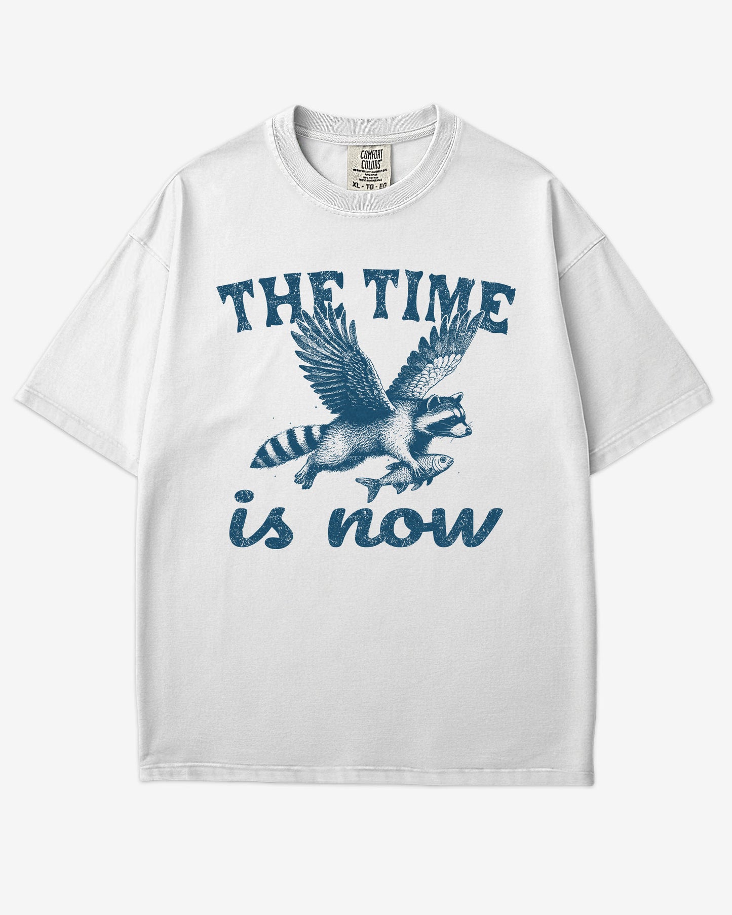 The Time Is Now Shirt flat lay unisex white retro tee with funny flying raccoon graphic