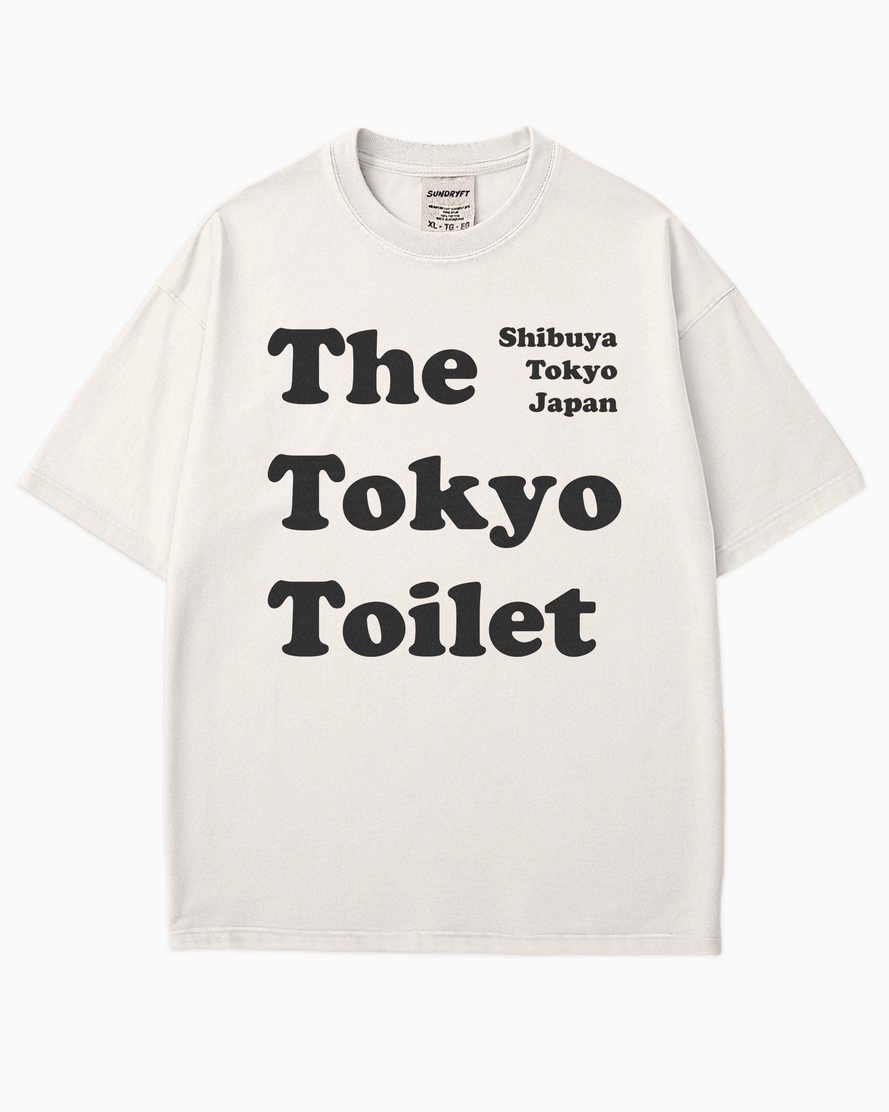 Flat lay ivory Tokyo Toilet shirt with a retro graphic inspired by Shibuya’s public restrooms.