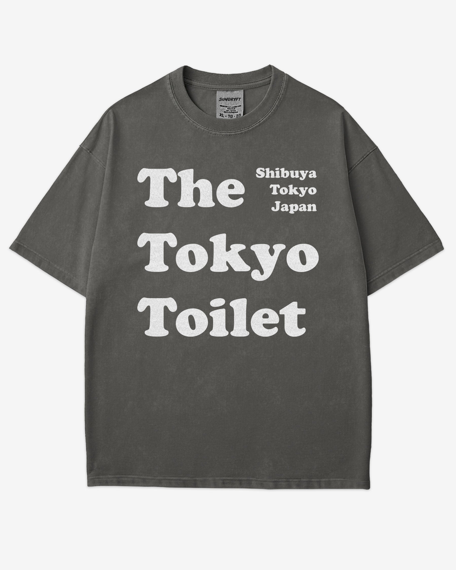 Flat lay pepper Tokyo Toilet shirt with a retro graphic inspired by Shibuya’s public restrooms.
