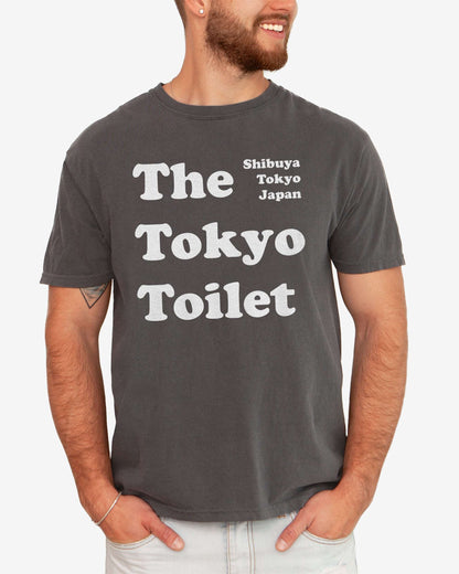 Man wearing a pepper Tokyo Toilet shirt with a retro graphic inspired by Shibuya’s public restrooms.