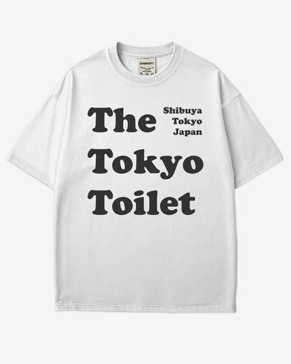 Flat lay white Tokyo Toilet shirt with a retro graphic inspired by Shibuya’s public restrooms.