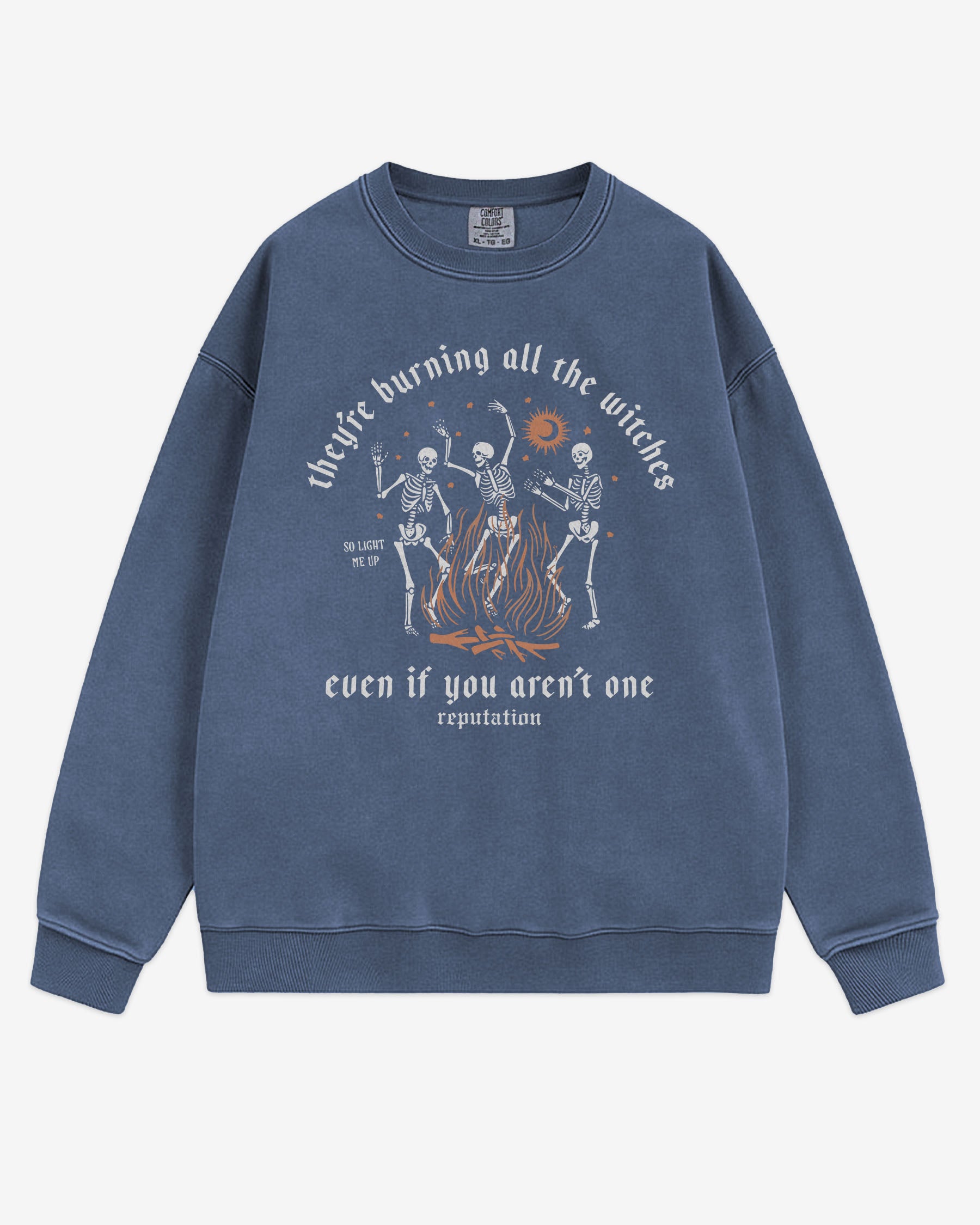 They’re Burning All The Witches Sweatshirt flat lay denim color retro graphic with skeletons dancing in fire