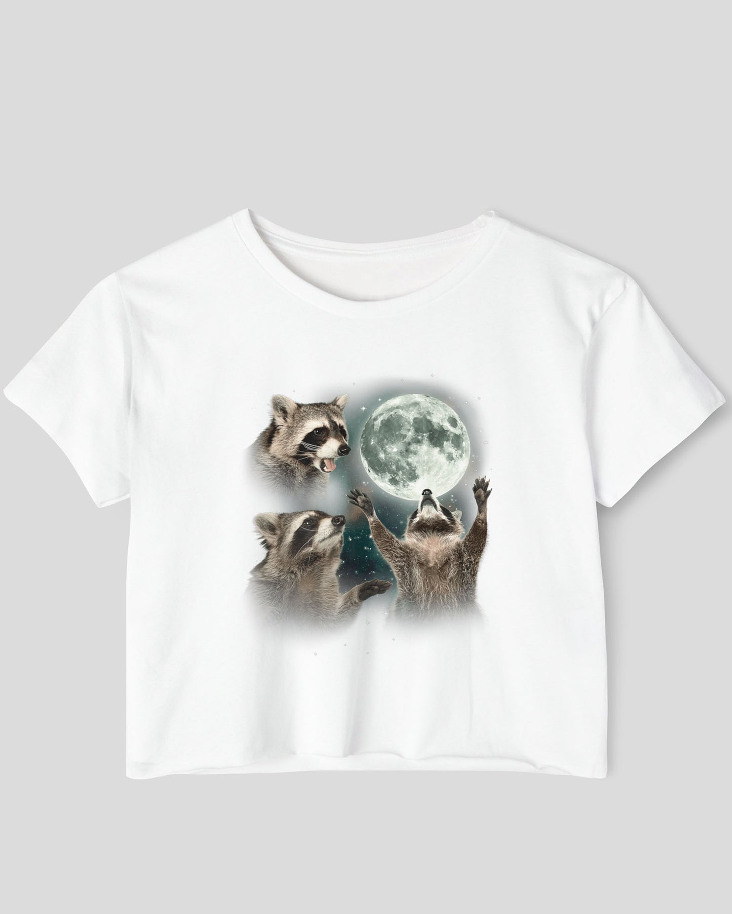 White crop top with a retro graphic of three raccoons howling at the moon.