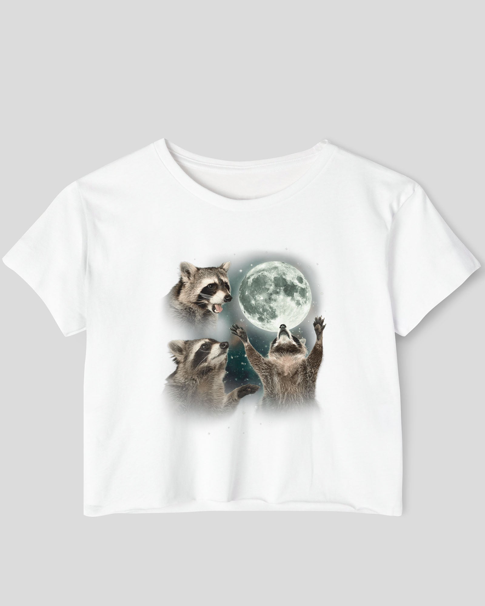 White crop top with a retro graphic of three raccoons howling at the moon.