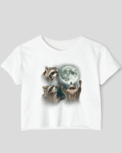 White crop top with a retro graphic of three raccoons howling at the moon.