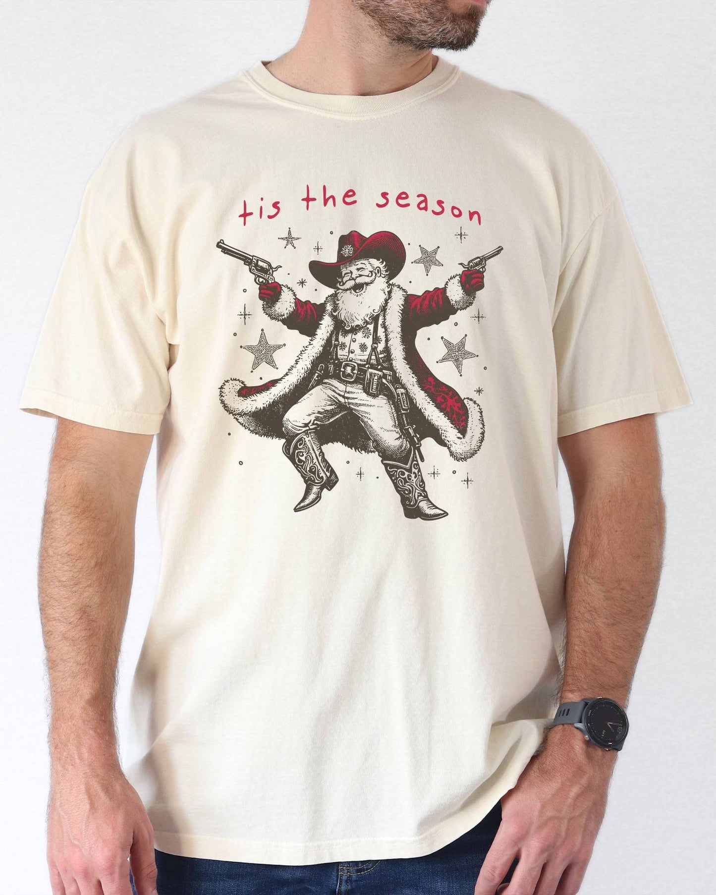 Model wearing ivory color shirt with 'Tis The Season' funny cowboy Santa Claus graphic design