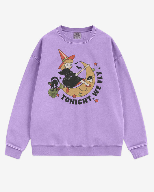 Flat lay orchid Tonight We Fly sweatshirt with retro witch on broomstick, moon, and black cat Halloween graphic clothing.