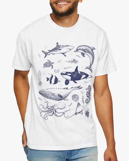 Man wearing a white shirt featuring a vintage 90s sea creatures collage graphic with whales, dolphins, turtles, and ocean life, perfect for retro nature lovers