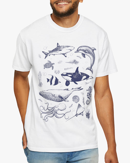 Man wearing a white shirt featuring a vintage 90s sea creatures collage graphic with whales, dolphins, turtles, and ocean life, perfect for retro nature lovers