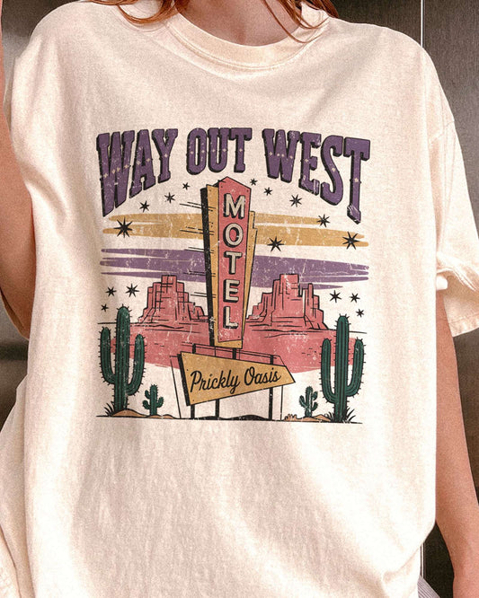 Close-up of woman wearing ivory color shirt with 'Way Out West Motel' western desert graphic design