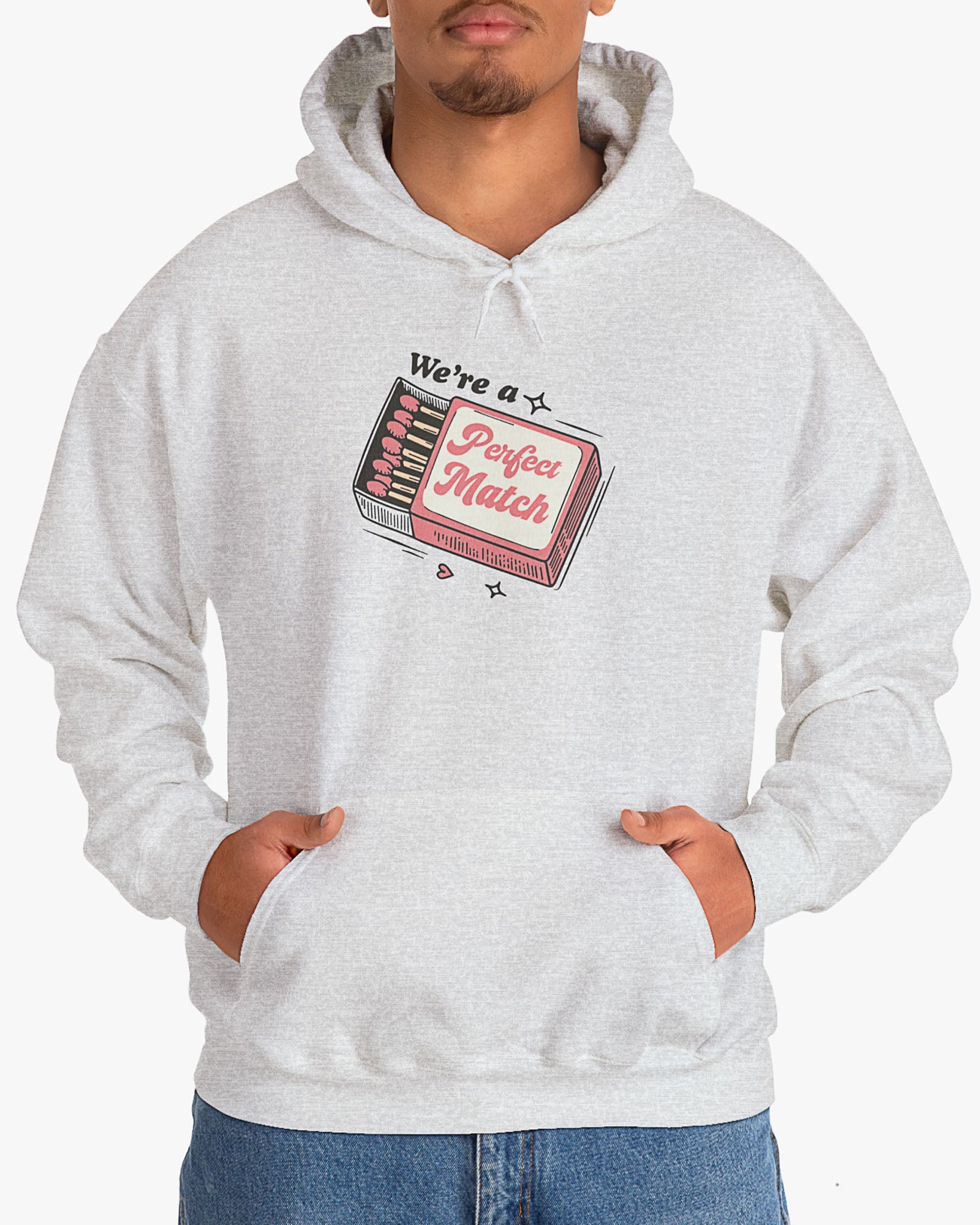 Man wearing ash gray 'We're A Match' hoodie with retro matchbox valentine's Day graphic