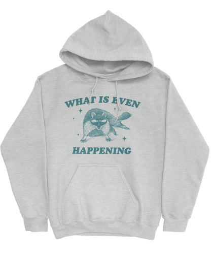 Flat lay of a white-colored 'What Is Even Happening' hoodie featuring a funny retro raccoon graphic.