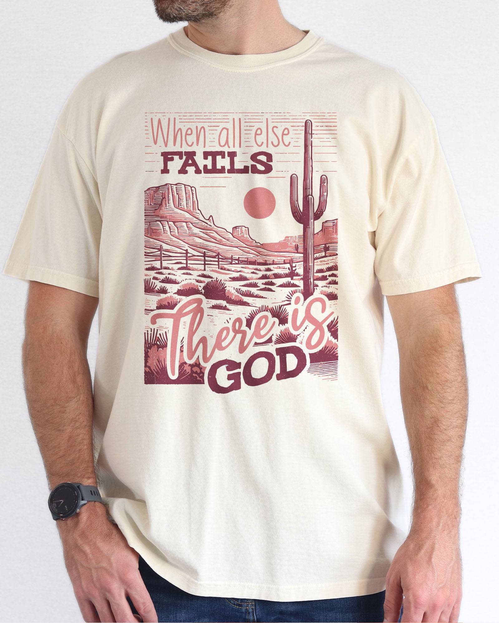 Man wearing natural color shirt with 'When All Fails There Is God' graphic design