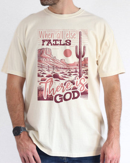 Man wearing natural color shirt with 'When All Fails There Is God' graphic design